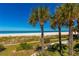 Lush tropical landscaping leads to a beautiful beach and ocean at 1390 Gulf Blvd # Ph-1, Clearwater Beach, FL 33767