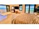 Ocean view main bedroom with king-size bed and dresser at 1390 Gulf Blvd # Ph-1, Clearwater Beach, FL 33767