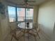 Cozy dining area with a glass table, seating for four, and views of the city from the large windows at 1540 Gulf Blvd # 2107, Clearwater Beach, FL 33767