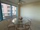 Cozy dining area with a glass table, seating for four, and views of the city from the large windows at 1540 Gulf Blvd # 2107, Clearwater Beach, FL 33767