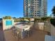 Outdoor grilling area with multiple stainless steel grills and a barstool-height island for seaside entertaining at 1540 Gulf Blvd # 2107, Clearwater Beach, FL 33767