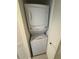 Efficient stacked washer and dryer unit neatly tucked away in a closet at 1540 Gulf Blvd # 2107, Clearwater Beach, FL 33767