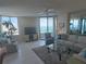 Bright living room with water views, tile flooring, and cozy seating around a glass coffee table at 1540 Gulf Blvd # 2107, Clearwater Beach, FL 33767