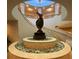 Grand lobby showcasing a modern sculpture set within a decorative water feature and staircase at 1540 Gulf Blvd # 2107, Clearwater Beach, FL 33767