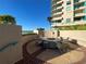 Coastal outdoor seating area with an ocean view, a circular table, and wooden chairs at 1540 Gulf Blvd # 2107, Clearwater Beach, FL 33767