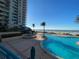 Beautiful outdoor pool and lounge area overlooking the beach with palm trees and lounge chairs at 1540 Gulf Blvd # 2107, Clearwater Beach, FL 33767