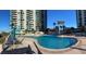 Expansive waterfront pool deck featuring lounge chairs and umbrellas with ocean views in a relaxing environment at 1540 Gulf Blvd # 2107, Clearwater Beach, FL 33767