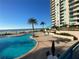 Beautiful outdoor pool and lounge area overlooking the beach with palm trees and lounge chairs at 1540 Gulf Blvd # 2107, Clearwater Beach, FL 33767