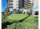 Lush putting green surrounded by green shrubs and palm trees at 1540 Gulf Blvd # 2107, Clearwater Beach, FL 33767