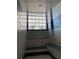 Well-lit shower with tiled walls, seating, and a glass block window at 1540 Gulf Blvd # 2107, Clearwater Beach, FL 33767