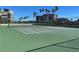 Scenic tennis court with blue sky and condo buildings in the distance at 1540 Gulf Blvd # 2107, Clearwater Beach, FL 33767