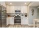 Modern kitchen with stainless steel appliances and white cabinetry at 102 Old Mill Pond Rd, Palm Harbor, FL 34683