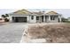 New construction home with gray siding, paver driveway, and a yellow accent at 142 Fairway Rd, Rotonda West, FL 33947