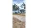 Side view of a light blue duplex with a gravel driveway and yard at 8417 N 47Th St, Tampa, FL 33617