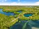 Aerial view of lush park with walking trails and waterways at 152 Carlyle Dr, Palm Harbor, FL 34683