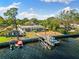 Aerial view of waterfront home with private dock and boat at 152 Carlyle Dr, Palm Harbor, FL 34683