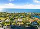 Aerial view of waterfront homes with lush landscaping and boat docks at 152 Carlyle Dr, Palm Harbor, FL 34683