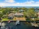 Aerial view of waterfront home with pool and private dock at 152 Carlyle Dr, Palm Harbor, FL 34683