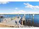 A waterfront dock with seating and a kayak at 152 Carlyle Dr, Palm Harbor, FL 34683