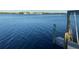 Wooden dock with calm water and distant houses at 152 Carlyle Dr, Palm Harbor, FL 34683