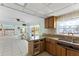 A galley kitchen with wood cabinets, granite countertops, and water views at 152 Carlyle Dr, Palm Harbor, FL 34683