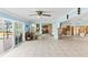 Living room with tiled floors and sliding doors to patio at 152 Carlyle Dr, Palm Harbor, FL 34683