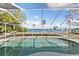 A kidney-shaped pool with a screened enclosure at 152 Carlyle Dr, Palm Harbor, FL 34683