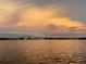 Amazing sunset view over calm water with distant houses at 152 Carlyle Dr, Palm Harbor, FL 34683