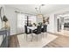 Elegant dining area with marble table, modern light fixture, and kitchen view at 155 Nina Way, Oldsmar, FL 34677