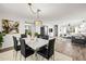 Bright dining room featuring a marble table and modern light fixture at 155 Nina Way, Oldsmar, FL 34677