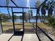 Screened patio with a view of the lake and palm trees at 155 Nina Way, Oldsmar, FL 34677