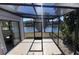 Screened porch with a scenic lake view, providing a serene and relaxing outdoor space at 155 Nina Way, Oldsmar, FL 34677