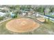 Aerial view of a park with a dog park, playground, and open space at 18518 Avocet Dr, Lutz, FL 33558