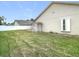 Fenced backyard with a grassy area and a white vinyl fence at 18518 Avocet Dr, Lutz, FL 33558