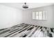 Well-lit bedroom featuring wood-look floors and ceiling fan at 18518 Avocet Dr, Lutz, FL 33558