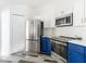 Modern kitchen with stainless steel appliances and blue cabinets at 18518 Avocet Dr, Lutz, FL 33558