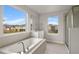 Elegant bathroom featuring a soaking tub, shower, and a large window at 3457 Timber Crossing Ave, Brandon, FL 33511