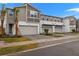 Three-unit townhome building with modern design, two-car garages, and landscaped yards at 3457 Timber Crossing Ave, Brandon, FL 33511