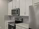 Modern kitchen with stainless steel appliances and white cabinets at 3457 Timber Crossing Ave, Brandon, FL 33511