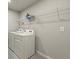 Bright laundry room features washer, dryer, and overhead shelving at 3457 Timber Crossing Ave, Brandon, FL 33511