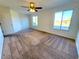 Spacious bedroom with carpeted floors and large windows at 4027 Harbor Lake Dr, Lutz, FL 33558