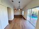 Dining area with wood-look floors and pool access at 4027 Harbor Lake Dr, Lutz, FL 33558