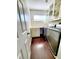 Laundry room with built-in cabinets and dark wood floors at 4027 Harbor Lake Dr, Lutz, FL 33558