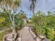 Landscaped backyard with brick path and tropical plants at 4608 S Shamrock Rd, Tampa, FL 33611