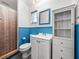 Clean bathroom with white vanity, blue wainscoting, and shower at 4608 S Shamrock Rd, Tampa, FL 33611