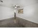 Bright bedroom with window, ceiling fan, and speckled flooring at 4608 S Shamrock Rd, Tampa, FL 33611