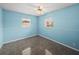 Light blue bedroom with carpet and two windows at 4608 S Shamrock Rd, Tampa, FL 33611