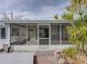 Exterior view of the home's screened patio and walkway at 4608 S Shamrock Rd, Tampa, FL 33611