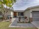 Inviting front entry with stone accents and landscaping at 4608 S Shamrock Rd, Tampa, FL 33611