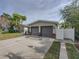 Two-car garage with gray doors and stone accents at 4608 S Shamrock Rd, Tampa, FL 33611